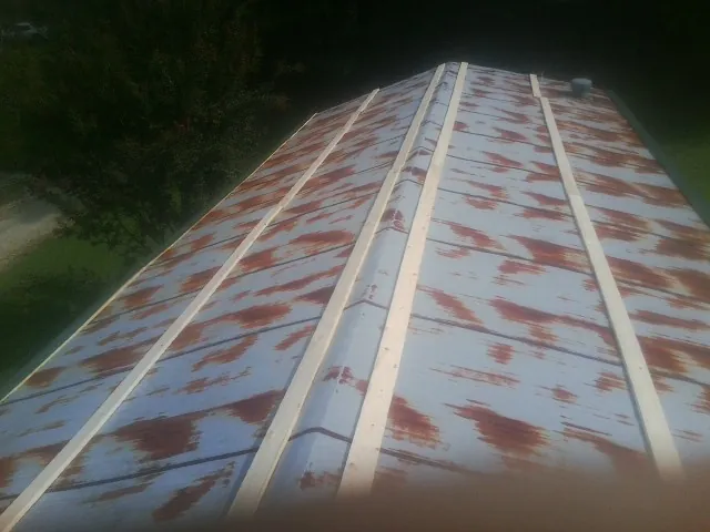 Rusted metal roof panels with new wood purlins before replacement — Storm Damage Roof Repair in Rocky by Roofing Brothers